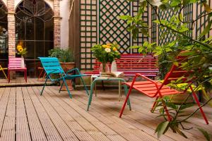 a group of chairs and tables on a patio at Hôtel Relais Monceau in Paris