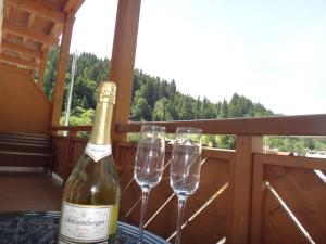 a bottle of wine and two wine glasses on a table at Apartment Kitzbichler by Apartment Managers in Kitzbühel