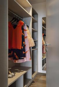 a walk in closet with gray walls and shelves at Sublimis Boutique Hotel Adults-Only in Camogli