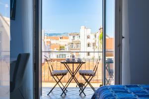 a room with a balcony with a table and chairs at Casa Ela in Sorrento