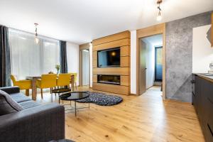 a living room with a couch and a table at RV Apartment Sapphire in Starý Smokovec