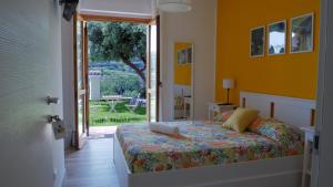 a bedroom with a bed and a sliding glass door at Talìa Residence in Porto San Giorgio