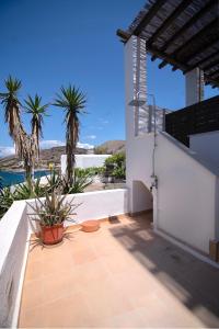 a balcony of a house with palm trees at Lotos Beach Home in Kini