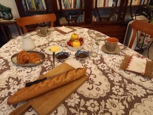 a table with a loaf of bread and a knife at chambre d hôtes les remparts in Saint-Cyprien