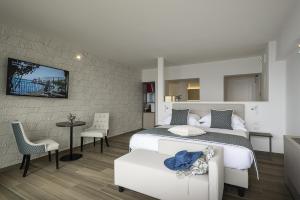 a bedroom with a bed and a table and chairs at Sublimis Boutique Hotel Adults-Only in Camogli