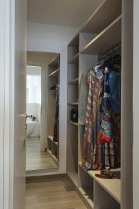 a walk in closet with shelves and a door at Sublimis Boutique Hotel Adults-Only in Camogli