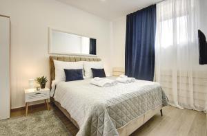 a bedroom with a bed with two towels on it at D&A Central Luxury Apartments with FREE Parking in Pula