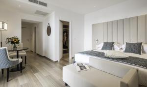 a bedroom with a bed and a table and a chair at Sublimis Boutique Hotel Adults-Only in Camogli