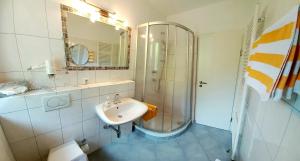 a bathroom with a sink and a shower at Apart-Pension Oberreiter in Fusch an der Glocknerstraße +102 photos