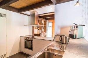 a kitchen with a sink and a stove at Apartment Adele - GRIWA RENT AG in Grindelwald
