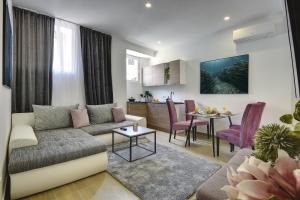 a living room with a couch and a table at D&A Central Luxury Apartments with FREE Parking in Pula