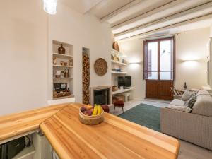 a living room with a table with a bowl of fruit at Marco's stylish home In the heart of Cagliari in Cagliari +26 photos