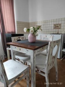 a table and chairs with a vase with flowers on it at Harmonica PREMIUM in Nowy Sącz +119 photos