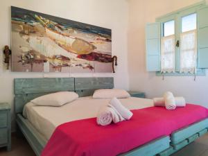 a bedroom with two beds with towels on them at Mistral-Patmos in Patmos