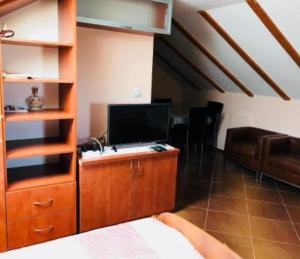 a living room with a tv on a wooden cabinet at Villa Sunrise in Herceg-Novi +26 photos