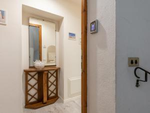a hallway with a mirror and a small table at Marco's stylish home In the heart of Cagliari in Cagliari