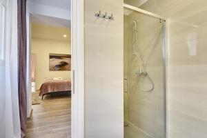 a bathroom with a shower and a bedroom at D&A Central Luxury Apartments with FREE Parking in Pula +37 photos