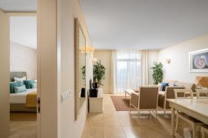 a living room with a bed and a dining room at Monte Santo Resort in Carvoeiro