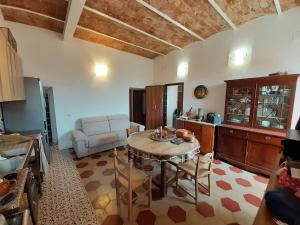 a kitchen and living room with a table and a couch at Pilarella Gallery trilocale vistamare in Porto Santo Stefano
