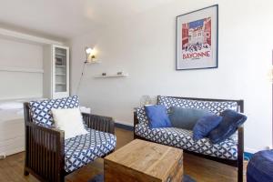 a living room with two chairs and a couch at Studio Thalmar - Welkeys in Biarritz