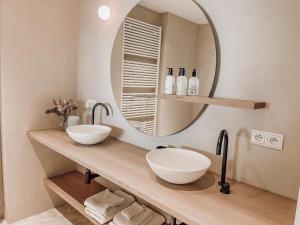 a bathroom with two sinks and a large mirror at ZETU The Dunes in Knokke-Heist