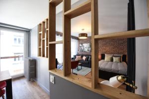 a room with a loft with a bed and a living room at Studio Ladrillo - Welkeys in Annecy +4 photos