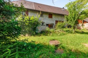 an old house in a yard with grass at Modern studio in a nice farm close to city-center - Welkeys in Annecy