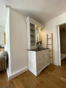 a bathroom with a sink and a mirror at Horenbecca studio met tuin zwembad & bistro in Horebeke