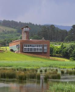 a building with a tower on the side of a lake at Urdaibai Bird Center in Gautegiz Arteaga