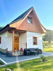 a white house with a brown roof at Góralski Domek u Marysi in Ochotnica Dolna