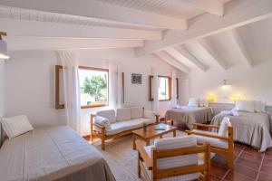 a living room with two beds and a couch at Villa Linda in Son Parc +31 photos