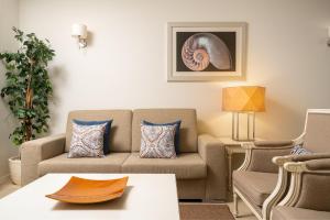 a living room with a couch and a table at Monte Santo Resort in Carvoeiro
