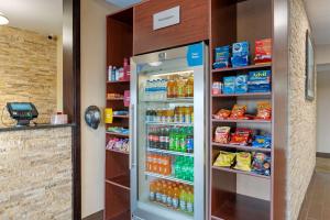 a refrigerator filled with lots of soda and drinks at Comfort Suites Miamisburg - Dayton South in Miamisburg