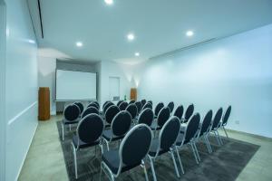 a conference room with chairs and a projection screen at Monte Santo Resort in Carvoeiro +37 photos