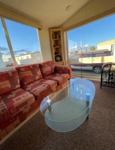 a living room with a couch and a glass coffee table at Steeple Bay F79 in Steeple