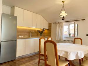 a kitchen with a white table and a refrigerator at Villa Adria in Vodice