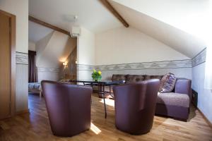 a living room with a couch and a table at Liepas in Ventspils
