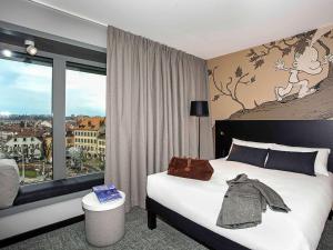 Postel nebo postele na pokoji v ubytování ibis Styles Genève Carouge