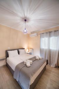 a bedroom with a large bed with towels on it at Marathos Apartment in Lefkada Town