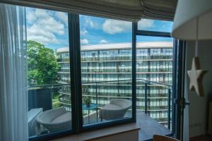 a room with a large window with a view of a building at 39DO in Druskininkai