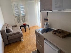 a kitchen with a sink and a chair in a room at Apartment Iva in Boreti