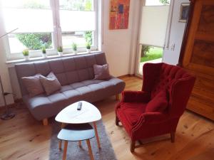a living room with a couch and a chair and a table at Ferienwohnung Am Michelsbach in Boppard