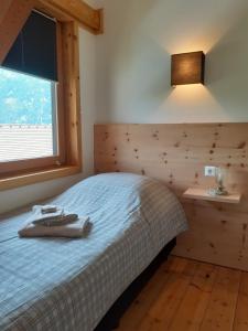 a bedroom with a bed and a window at Ferienhaus Herrenschmiede in Obervellach