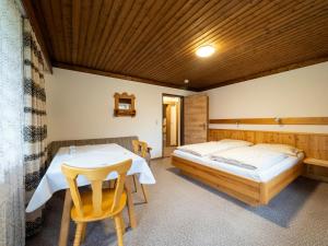 a bedroom with two beds and a table at Brandtnerhof Betriebe in Waidring