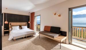 a bedroom with a bed and a balcony at Atmospheres in Le Bourget-du-Lac