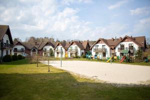 a group of houses with a playground in a park at Apartament Korab in Żarnowska