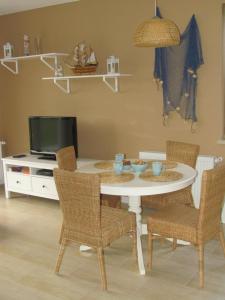 a dining room with a white table and chairs at Apartament Korab in Żarnowska