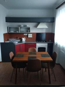 a kitchen with a wooden table and some chairs at Ubytování Velký Týnec 376 in Velký Týnec