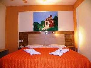 Ένα ή περισσότερα κρεβάτια σε δωμάτιο στο Mirabelle Hotel