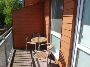 a balcony with two chairs and a table at Zempin Ostseepark WE 32 Insel Used in Zempin